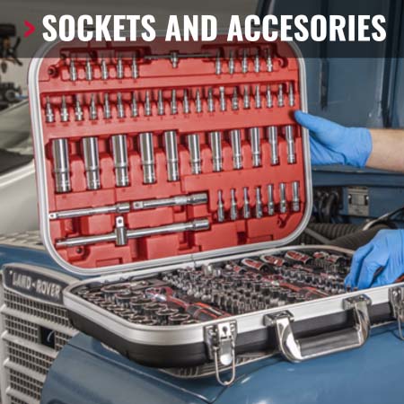 Sockets and Accesories at Joe Mckenna's. Mechanic rolling out a spanner and wrench set on top of a car engine.